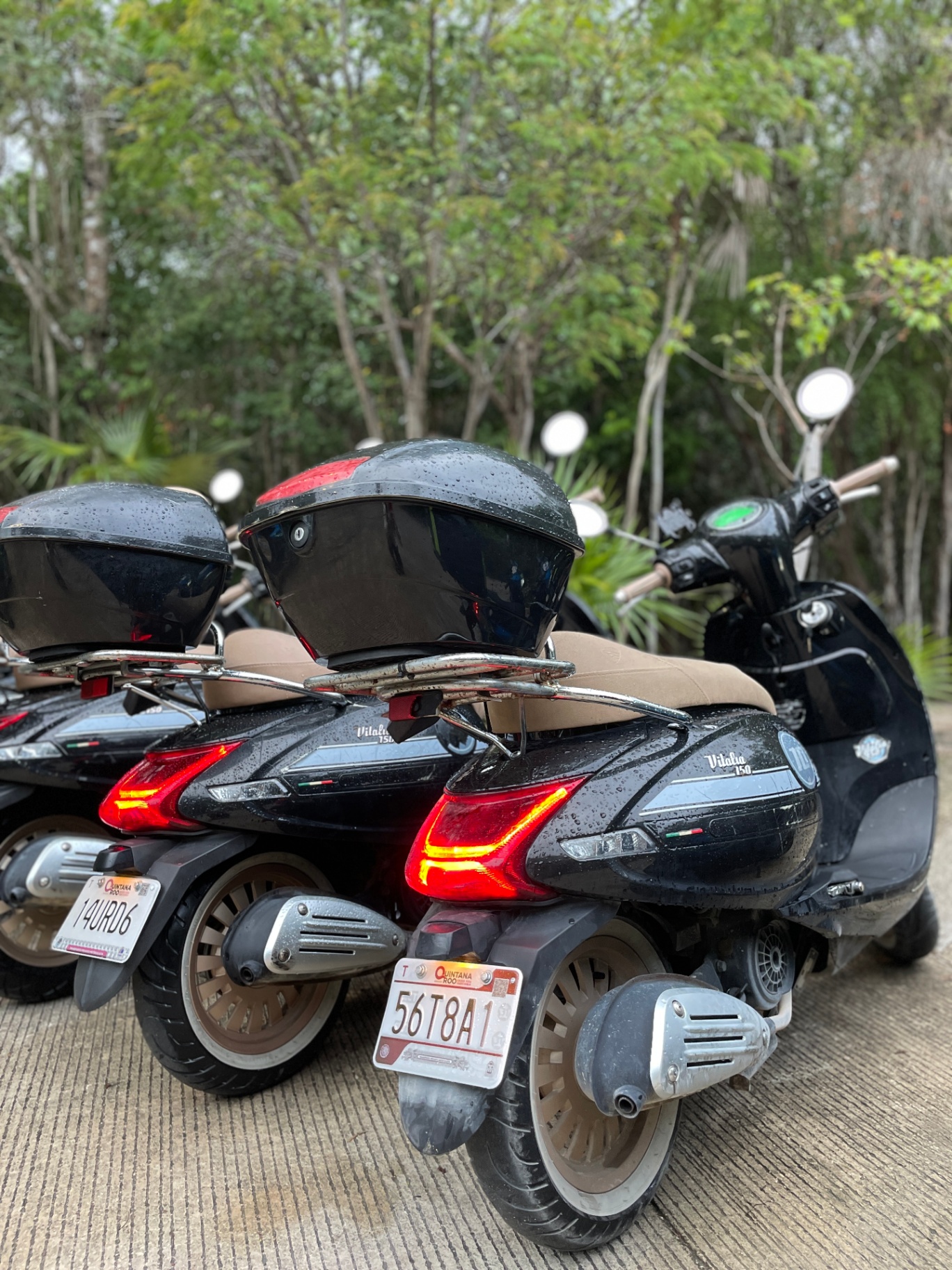 Rear view of a retro scooter with a top box